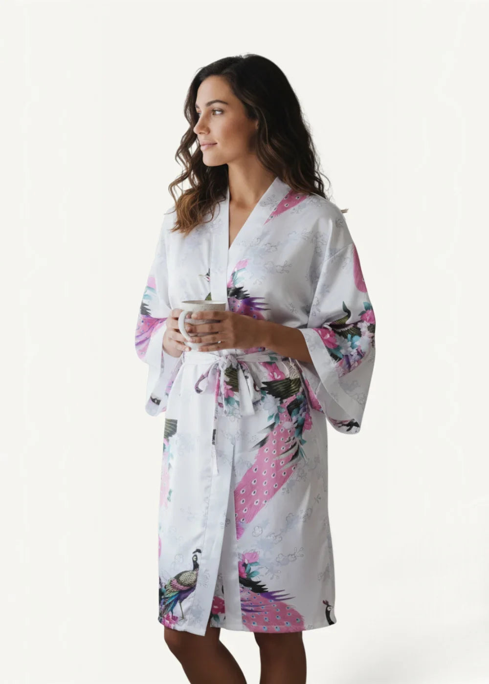Knee length satin robe in white silk with vibrant pink and purple peacock patterns visible from the back side