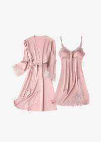 A delicate pink satin lace nightgown and robe set with sheer camisole and elegant embroidery details