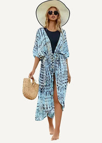 Light kimono beach cover-up in light blue and navy tie-dye with belted waist, side slit, and three-quarter sleeves