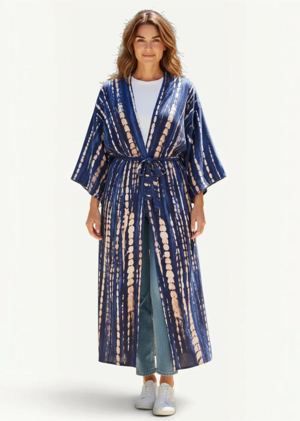 A flowing navy blue tie-dye lightweight kimono cover up with wide sleeves and a belted waist