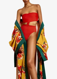 Long floral kimono duster with bold yellow and green floral patterns paired with a vibrant red strapless high-cut bikini set
