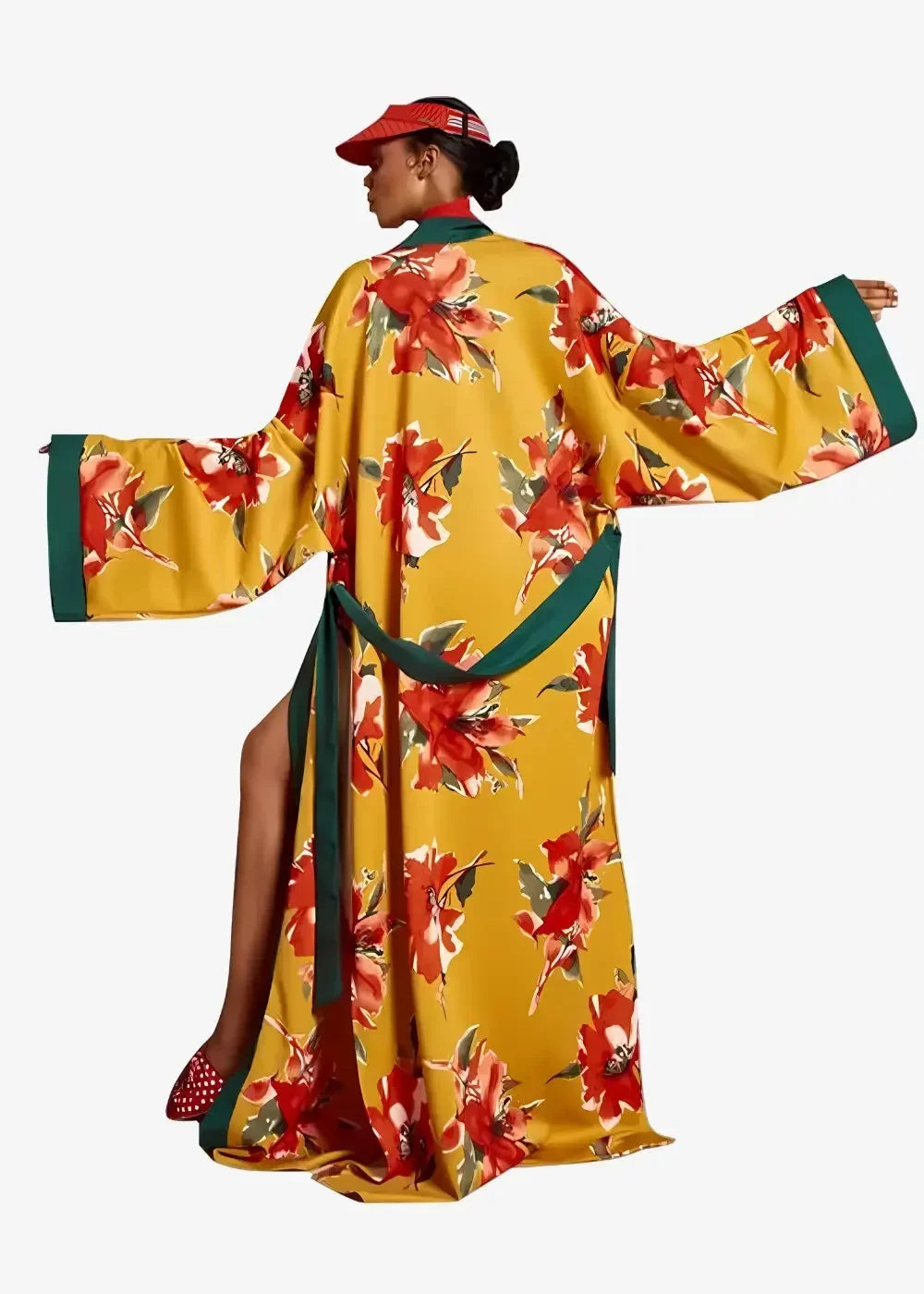 Long floral kimono duster with vibrant yellow fabric, bold red blossoms, green leaves, and emerald trim accents