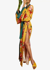 Long floral kimono duster in vibrant yellow with bold red and green accents, high slit, and wide sleeves
