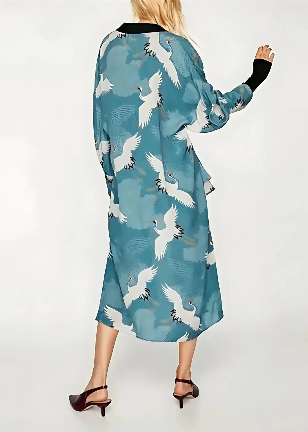 Long kimono duster with a flowing teal robe featuring a white crane print and black trim at the collar