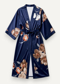 Long kimono robe in navy blue satin with brown and white floral pattern and matching belt tied at the waist