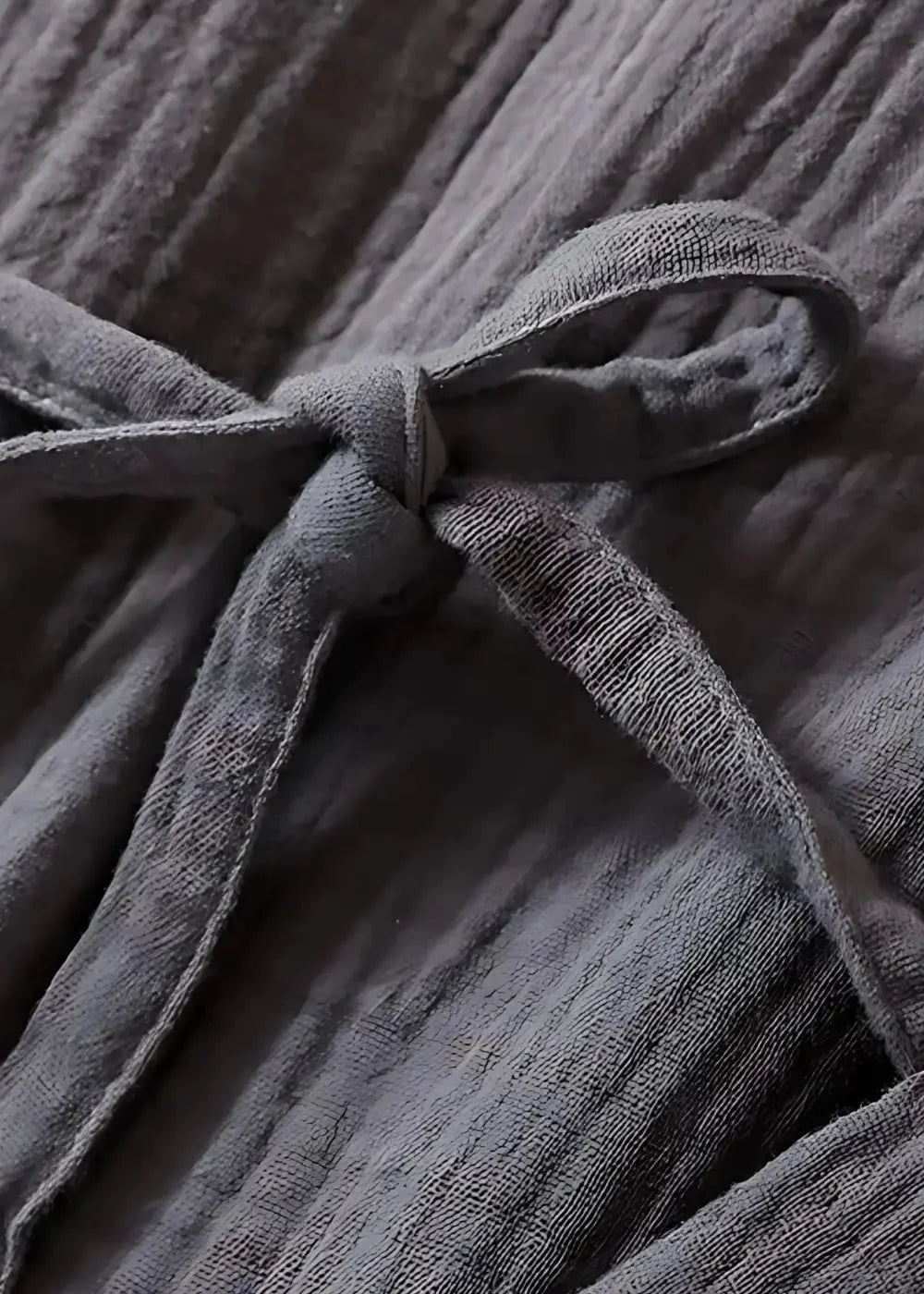 Gray ribbed cotton drawstring tied in a knot on the long kimono style dressing gown