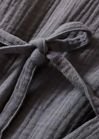 Gray ribbed cotton drawstring tied in a knot on the long kimono style dressing gown