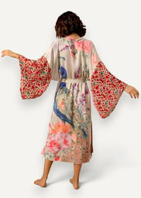 Long white kimono cover up made of flowing light beige silk with vibrant peacock and floral pattern in pink red blue and green