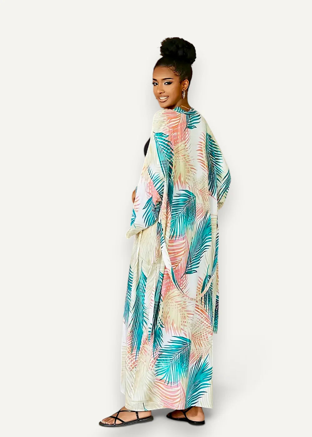 Long white kimono dress beach cover-up with long sleeves and vibrant teal and coral tropical leaf print on off-white fabric