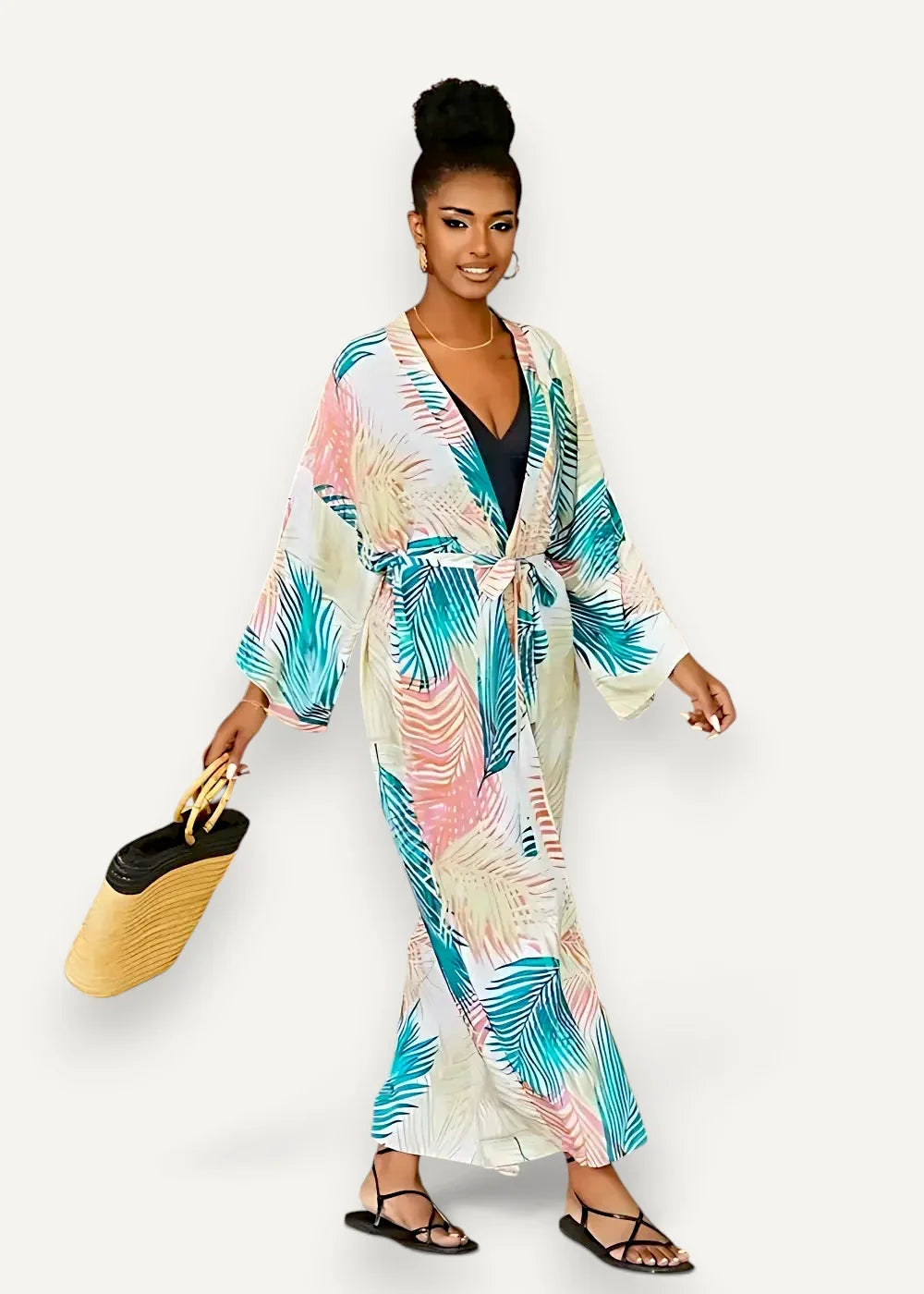 Long white kimono dress with long sleeves and vibrant tropical teal pink and cream palm leaf print on light fabric