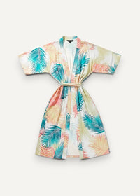 Long white kimono dress with vibrant tropical palm leaf print in soft pastel teal coral and cream hues