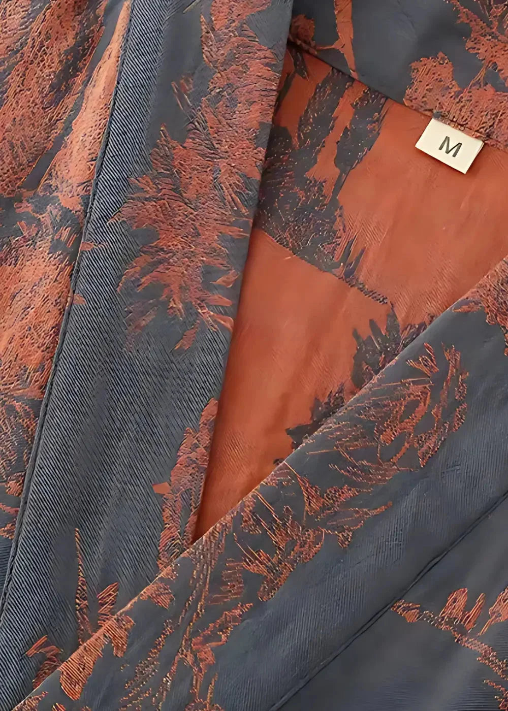 Close-up of the men's silk kimono collar, dark blue with a rust leaf pattern and orange lining