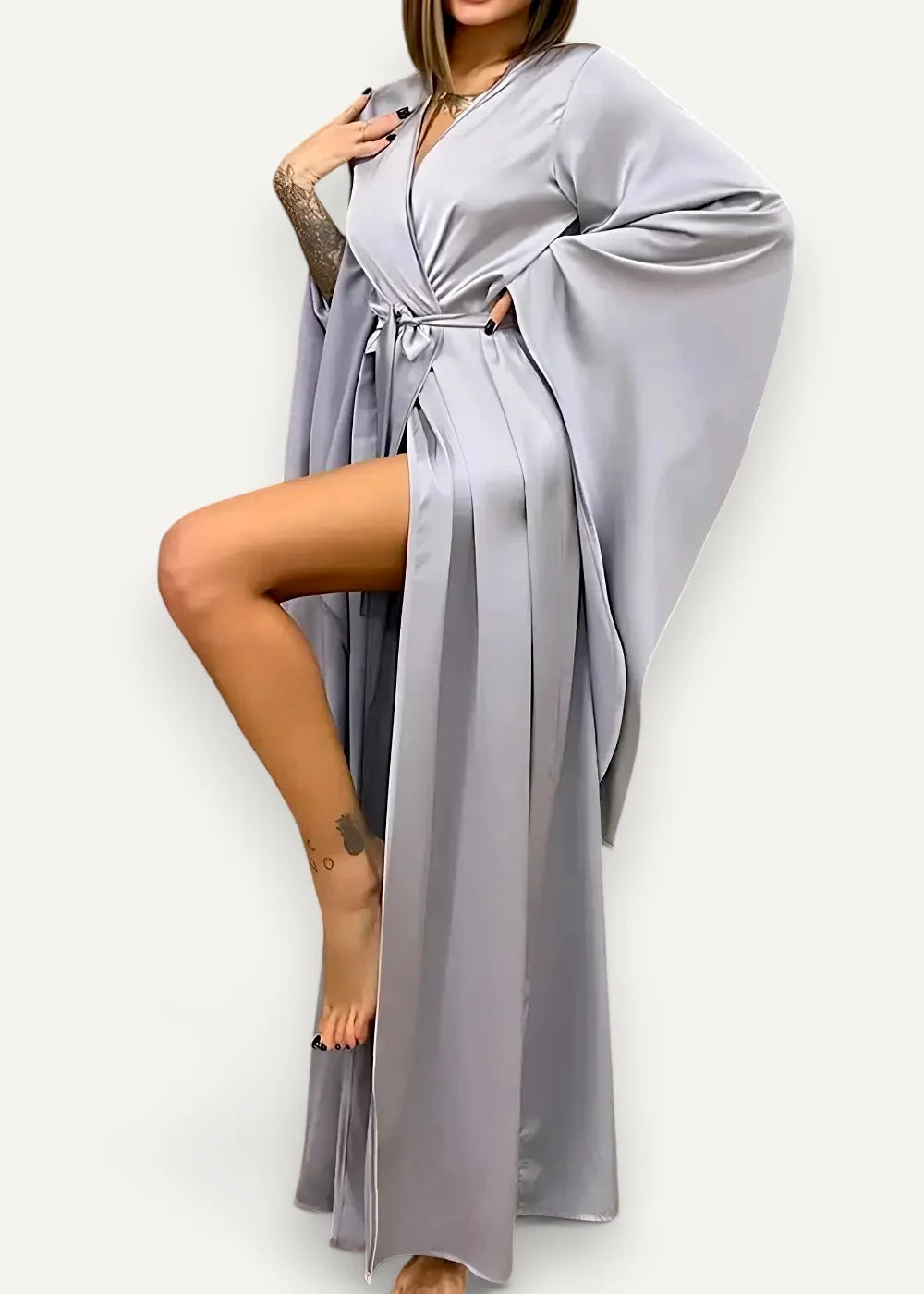 A flowing light gray satin modern kimono dress with wide sleeves and a belted waist