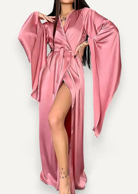 A flowing pink satin modern kimono dress with wide bell sleeves and a high slit