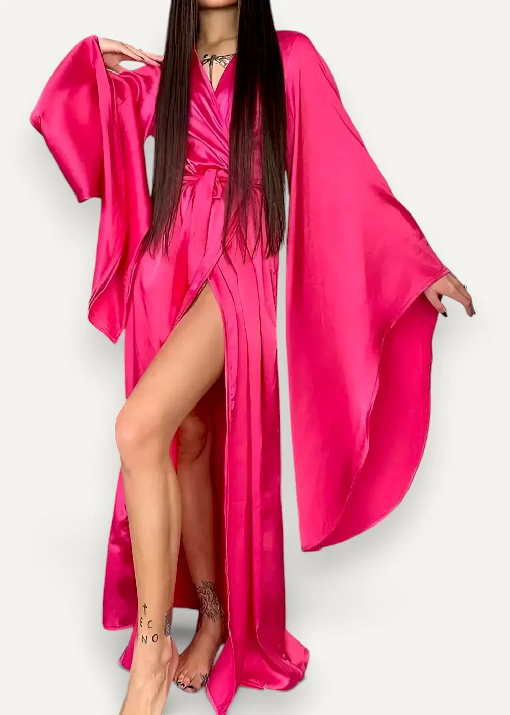 A vibrant fuchsia satin modern kimono dress with wide flowing sleeves and a high slit