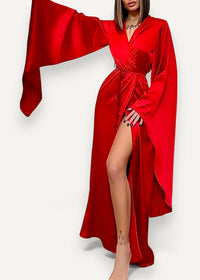 A flowing vibrant red satin modern kimono dress with wide bell sleeves and a high slit
