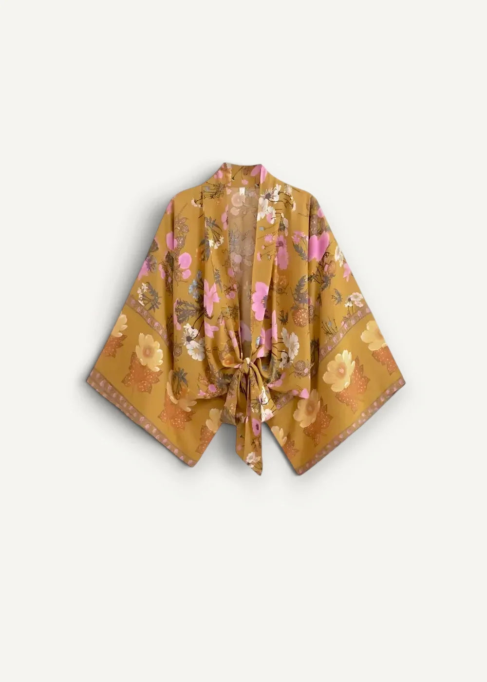 A flowing mustard-yellow modern kimono top with wide sleeves floral pattern in soft pinks and golds and tied front