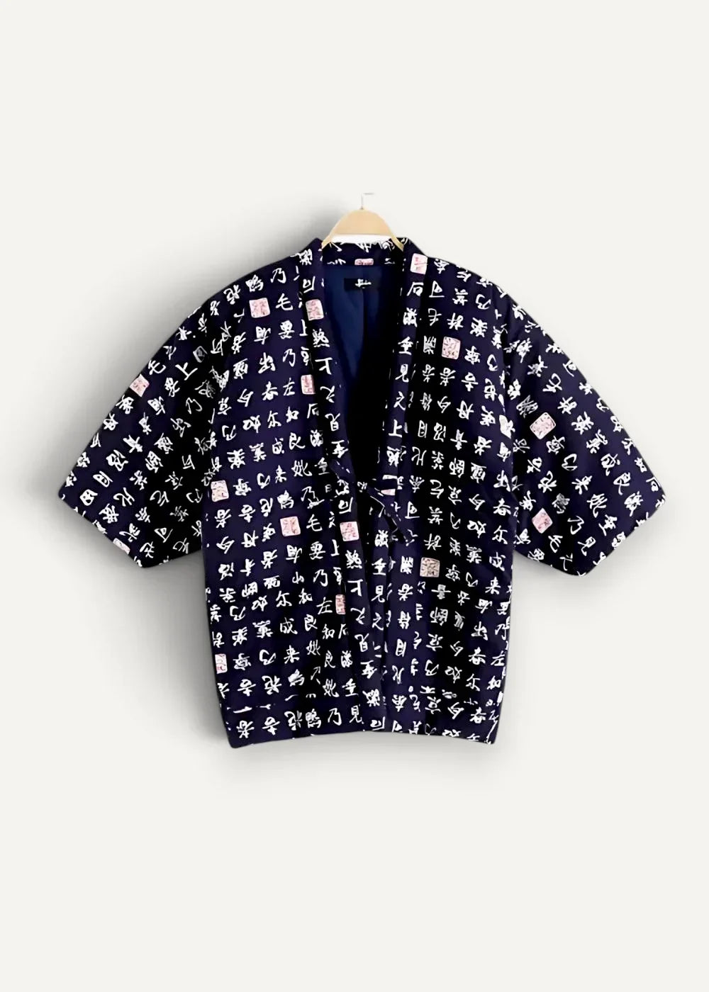 Navy blue kimono jacket with short sleeves featuring white calligraphy and small pink seal motifs on fabric