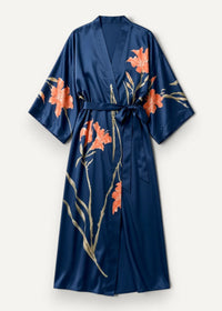 Navy blue satin robe with vibrant orange floral pattern and gold-toned stems, featuring a matching belt tied at the waist