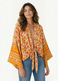 Open front swim cover up kimono with flowing orange and cream floral print wide sleeves and waist tie