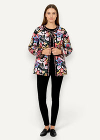 A vibrant padded kimono coat with a black base, floral quilted pattern, and embroidered collar and front placket