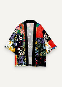 A vibrant patchwork kimono jacket with bold red purple and yellow floral patterns on black fabric