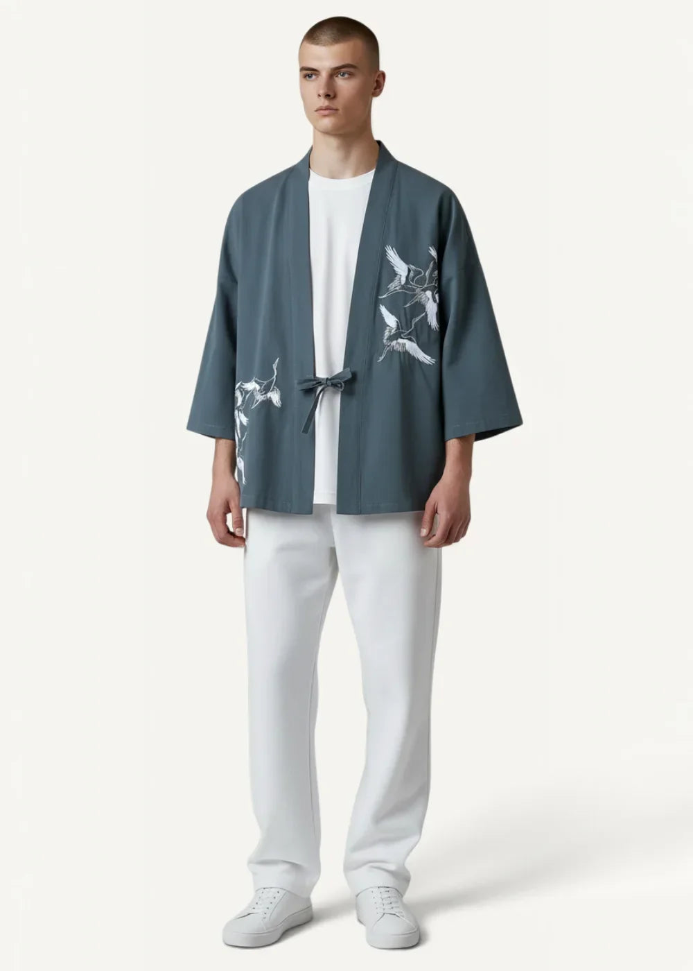 A men’s slate blue patterned kimono jacket with white bird and branch embroidery and a tied waistband