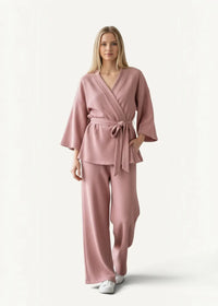 A soft pink cotton ribbed knit wrap top with matching wide-leg pants in a pink cotton kimono pajamas set