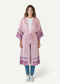 A flowing pink and purple floral kimono cover up with tie waist design made from lightweight fabric