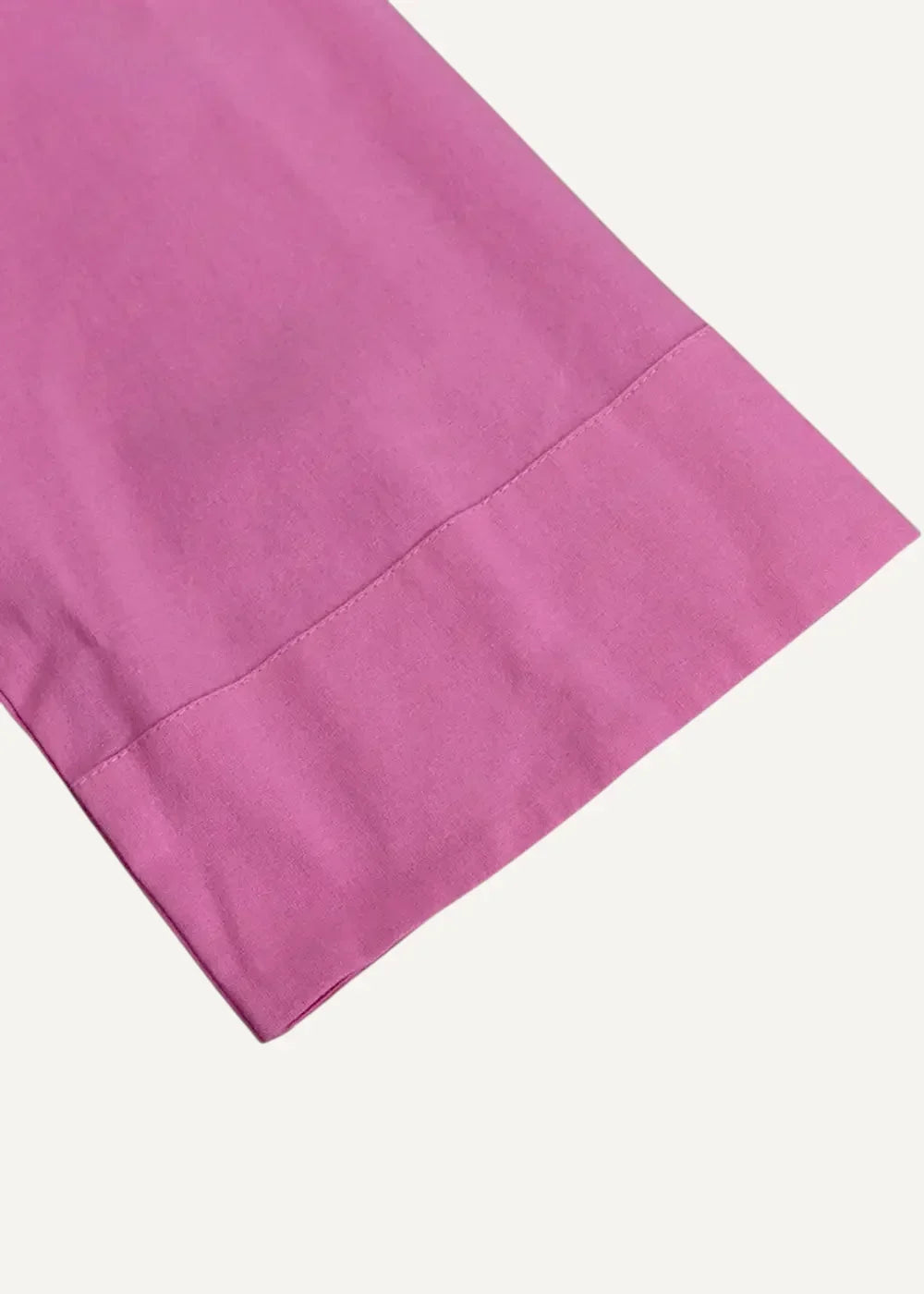 Close-up of the pink kimono dress sleeve with a neatly stitched hem