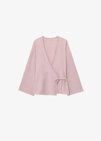 A soft blush pink kimono set featuring a wrap-style top with wide sleeves and a tied waist detail