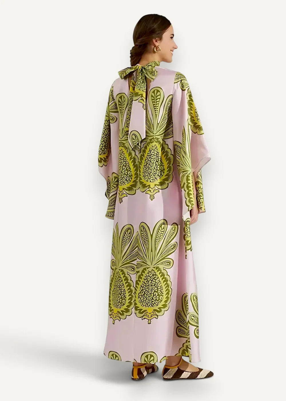 Pink kimono style dress flowing maxi length with bold green leafy pattern and wide flared sleeves