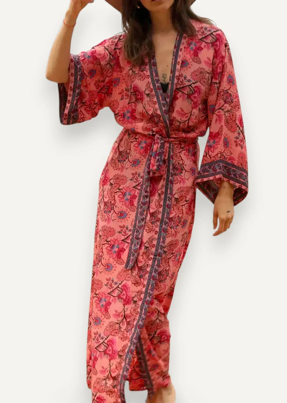 Pink satin kimono dress with flowing floral robe design, matching belt, and dark patterned trim on sleeves and sides