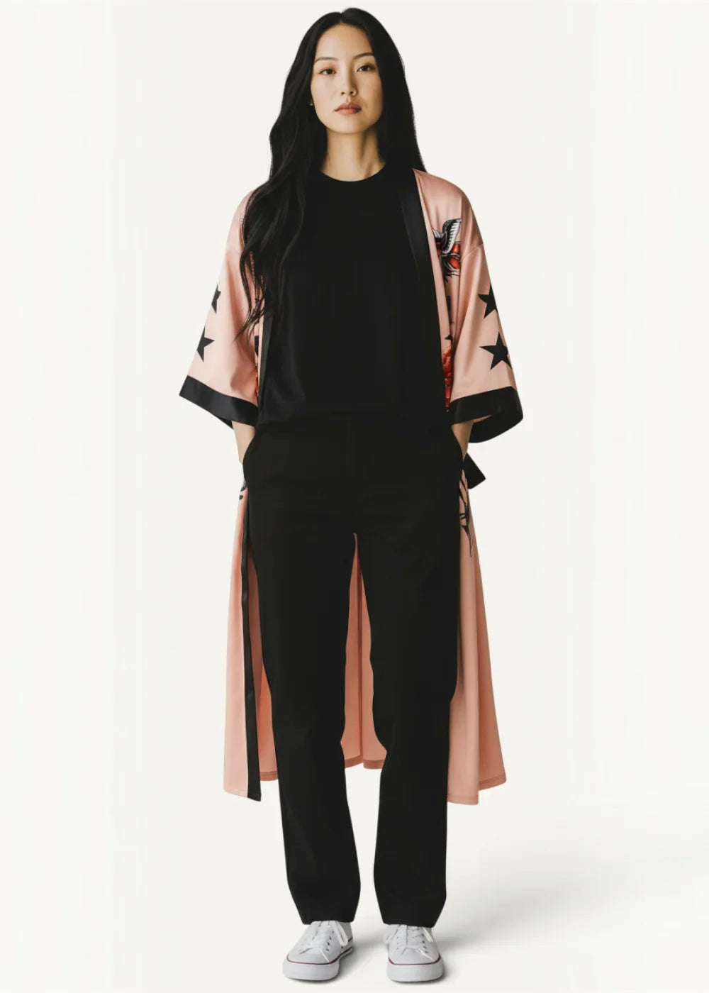 Pink satin kimono robe in soft silk with black star and bird embroidery worn over a black outfit