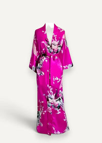 A vibrant fuchsia pink silk robe with a floral pattern featuring pink white and black blossoms