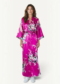 A vibrant fuchsia pink silk robe with floral pattern featuring pink white and dark gray blossoms
