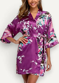 Purple satin kimono robe with a vibrant floral pattern in pink white and teal on smooth satin fabric