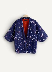 Navy blue quilted kimono jacket with pink and white cherry blossom pattern and vibrant orange lining