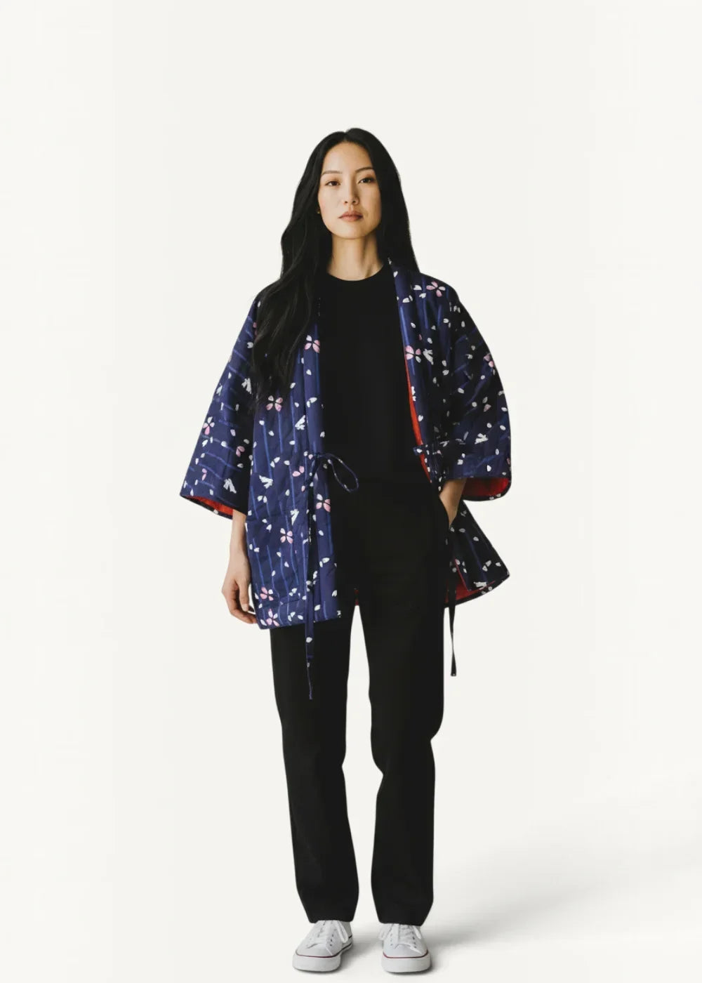 Navy blue quilted kimono jacket with white and pink floral motifs red inner lining and drawstring ties