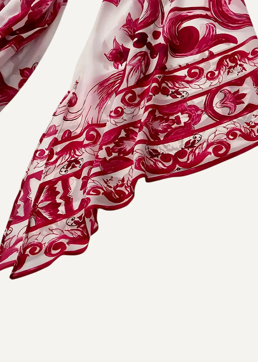 Close-up of the red floral print kimono maxi dress fabric, white with bold red ornamental patterns