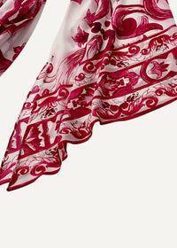 Close-up of the red floral print kimono maxi dress fabric, white with bold red ornamental patterns