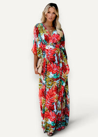 Red kimono dress featuring a vibrant tropical leaf print maxi design in flowing lightweight fabric with v neck and three quarter sleeves