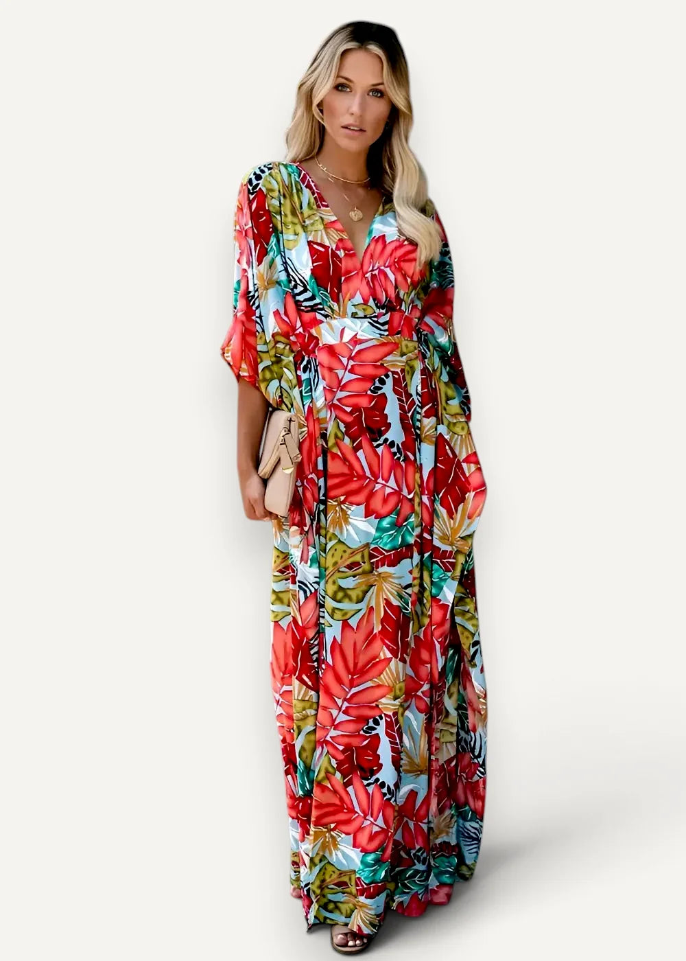 Red kimono dress featuring a vibrant tropical leaf print maxi design in flowing lightweight fabric with v neck and three quarter sleeves