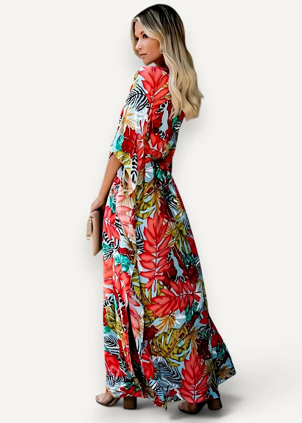 A red kimono dress featuring a vibrant tropical print maxi style with bold red green and black leaves on light blue fabric