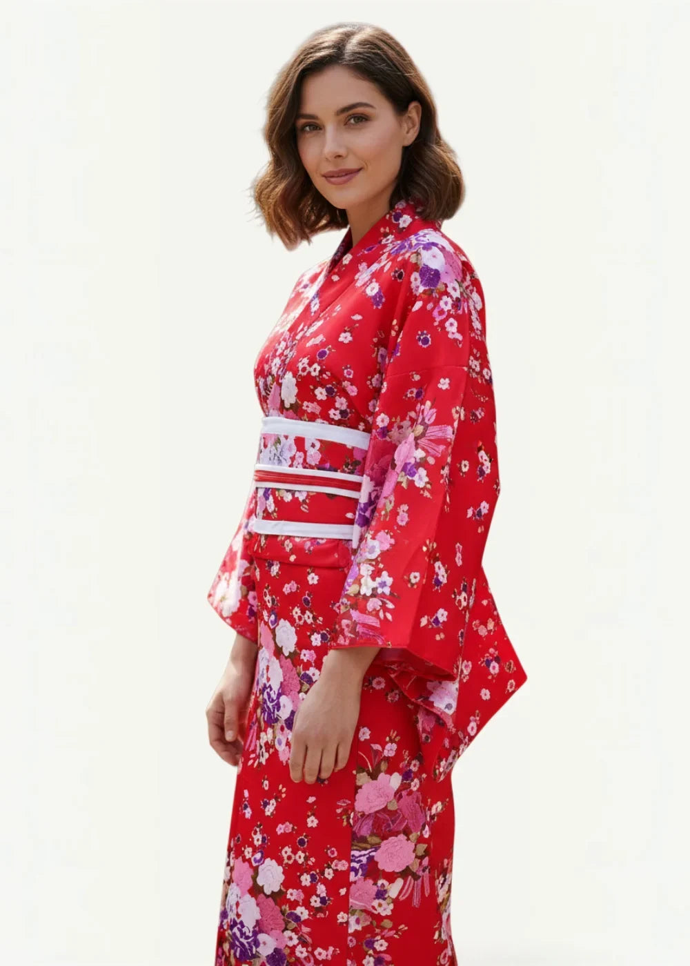A vibrant red kimono traditional with delicate pink and purple floral patterns wide sleeves and a white obi belt