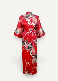 A vibrant red silk robe with a delicate pink white and green floral pattern for elegant lounging