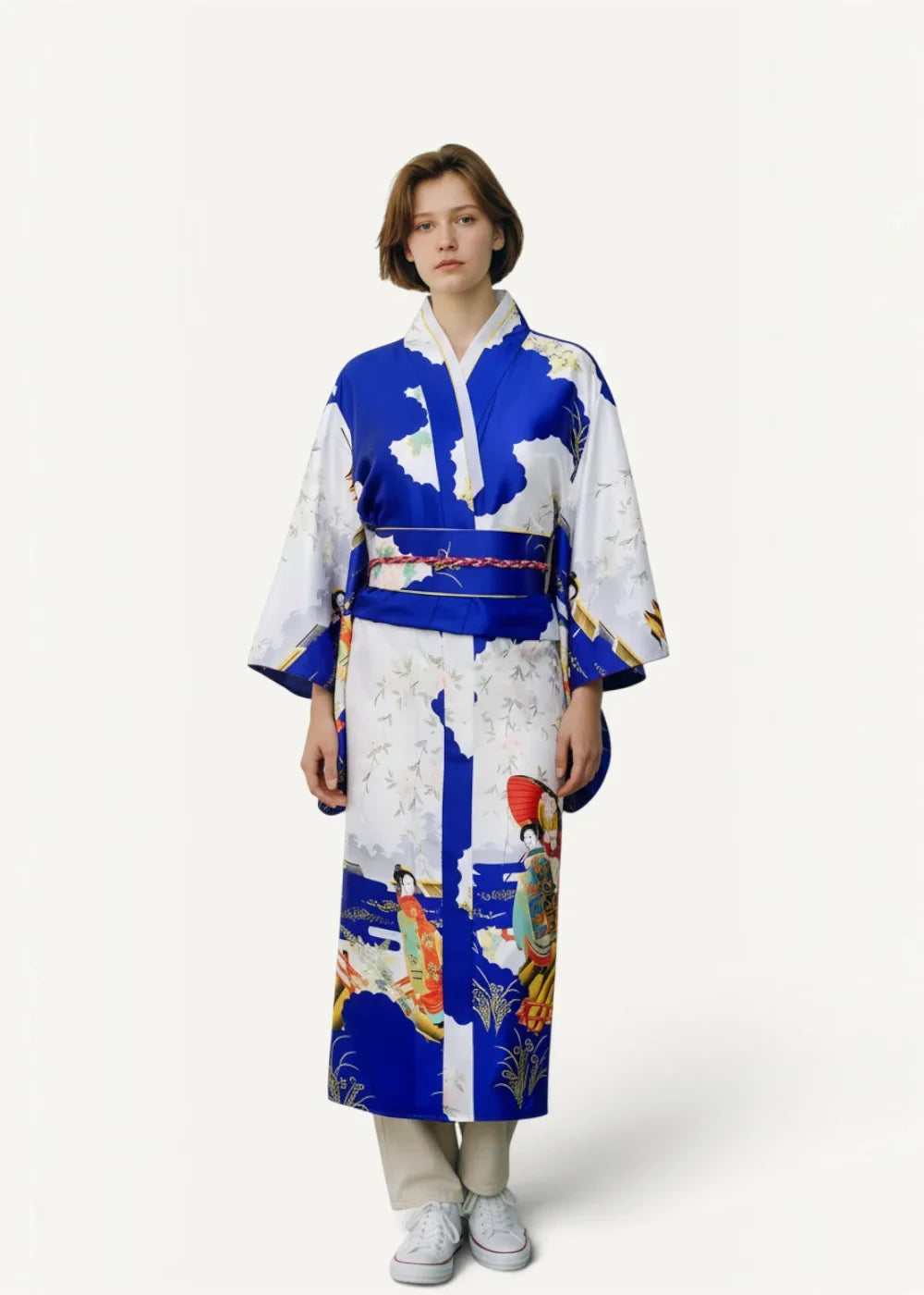 A woman wearing a vibrant blue and white satin dressing robe with traditional Japanese geisha and nature illustrations