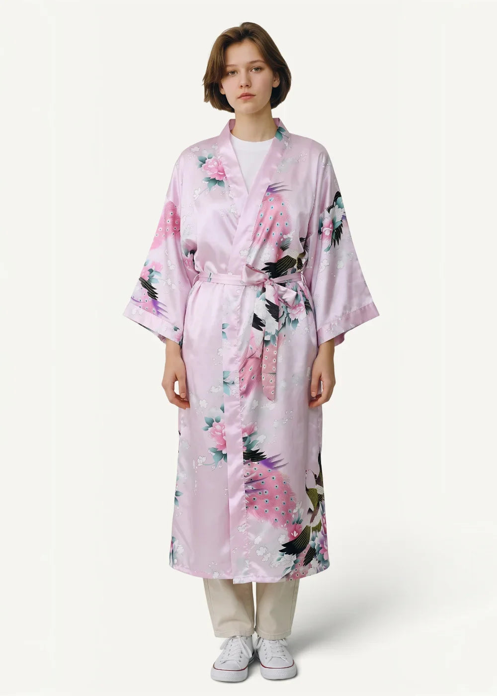 A soft pink satin Japanese kimono robe with a floral and bird pattern and a matching waist belt