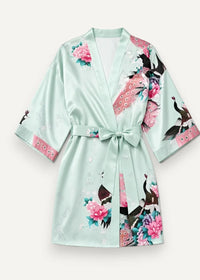 A mint green satin kimono robe short with a vibrant peacock and pink floral pattern and matching belt