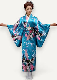 A vibrant turquoise satin kimono with a glossy finish featuring intricate pink white and black floral and bird patterns